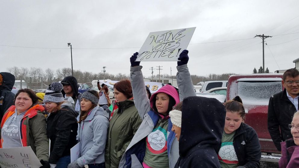 PHOTO: A young resident holds up a sign reading 'Native Votes Matter' while marching to a polling place on the Turtle Mountain Indian Reservation in Belcourt, N.D., Nov. 6, 2018.