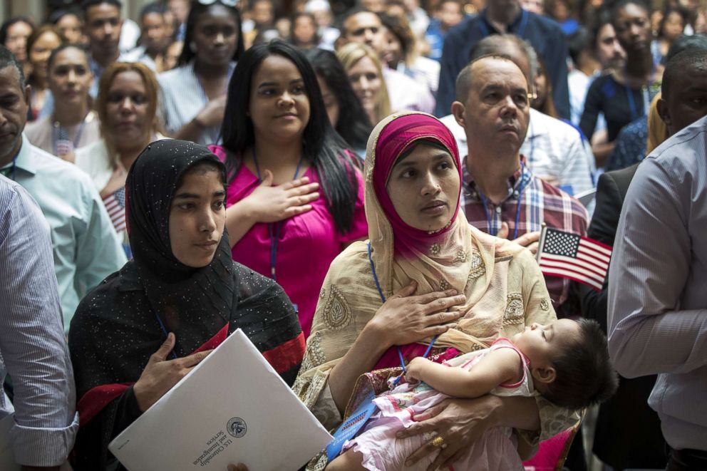 PHOTO: Mosammat Rasheda Akter, originally from Bangladesh, recites the Pledge of Allegiance after officially becoming a U.S. citizen during a naturalization ceremony at the New York Public Library, July 3, 2018.