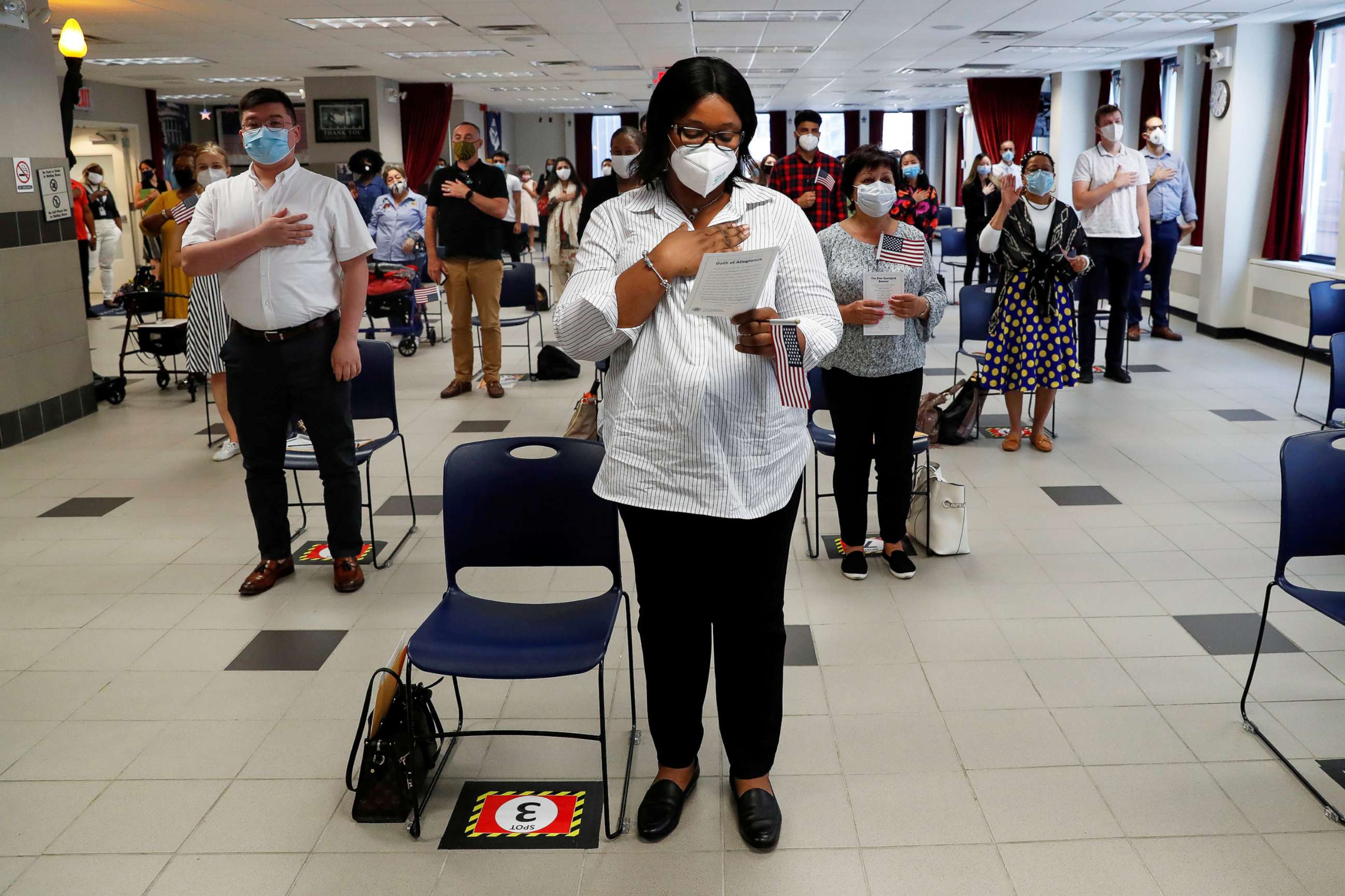 PHOTO: Ifeoma Eh, a citizen candidate from Nigeria, stands with others during a U.S. Citizenship and Immigration Services naturalization ceremony in New York, July 22, 2020.