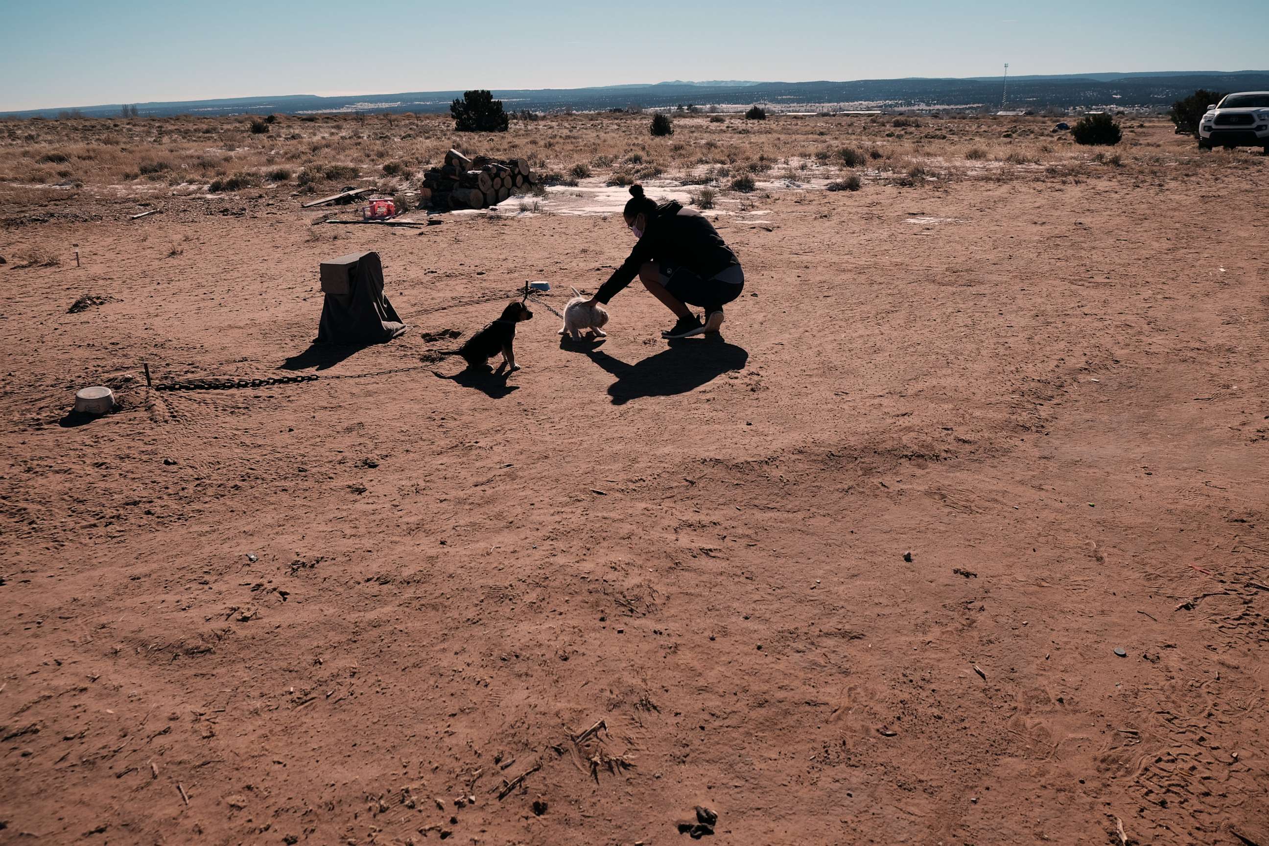 PHOTO: Carleena Chavez pets a dog outside of her home, which doesn't have running water on the Navajo Nation on Dec. 16, 2021, in Thoreau, New Mexico.