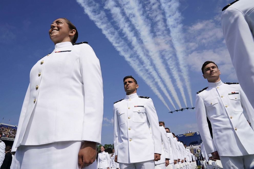 PHOTO: Midshipmen stand at attention during a Blue Angels fly over prior to Vice President Kamala Harris delivering an address for the U.S. Naval Academy graduation and commissioning ceremony in Annapolis, Md., May 28, 2021.