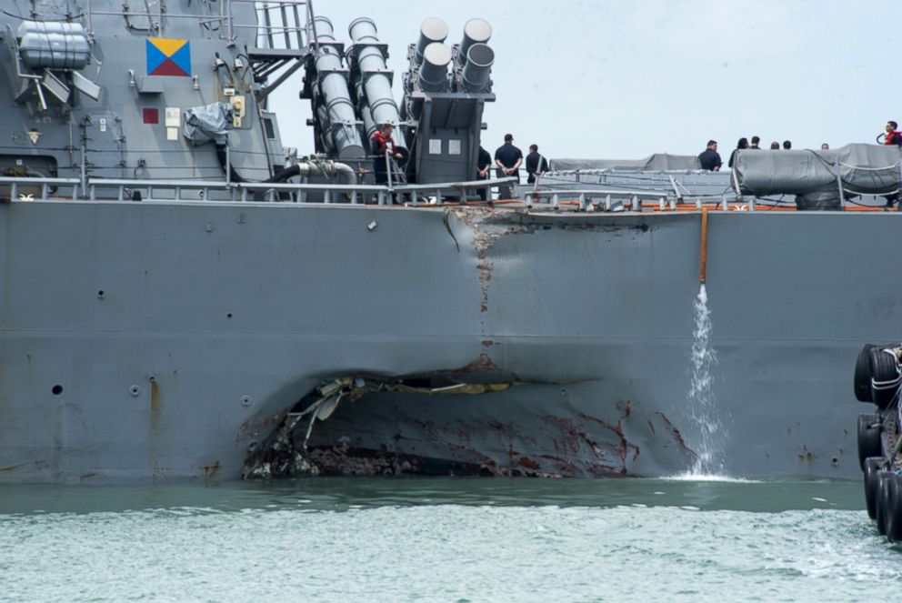 PHOTO: Damage to the portside is visible as the Guided-missile destroyer USS John S. McCain (DDG 56) steers towards Changi naval base in Singapore following a collision with the merchant vessel Alnic MC, Aug. 21, 2017. 