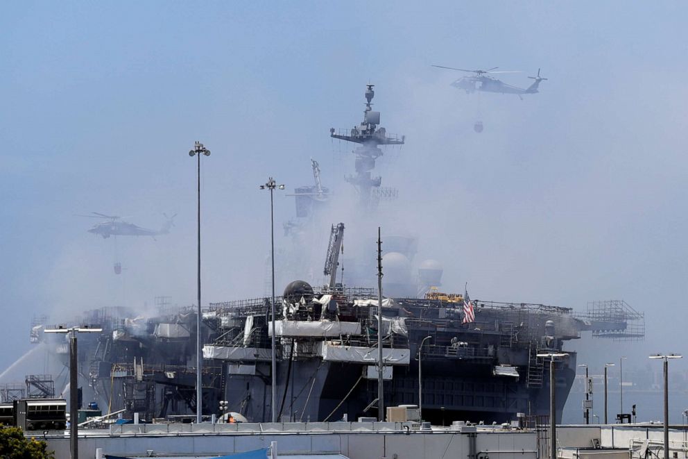 PHOTO: Helicopters approach the USS Bonhomme Richard as crews fight the fire in San Diego, July 13, 2020.