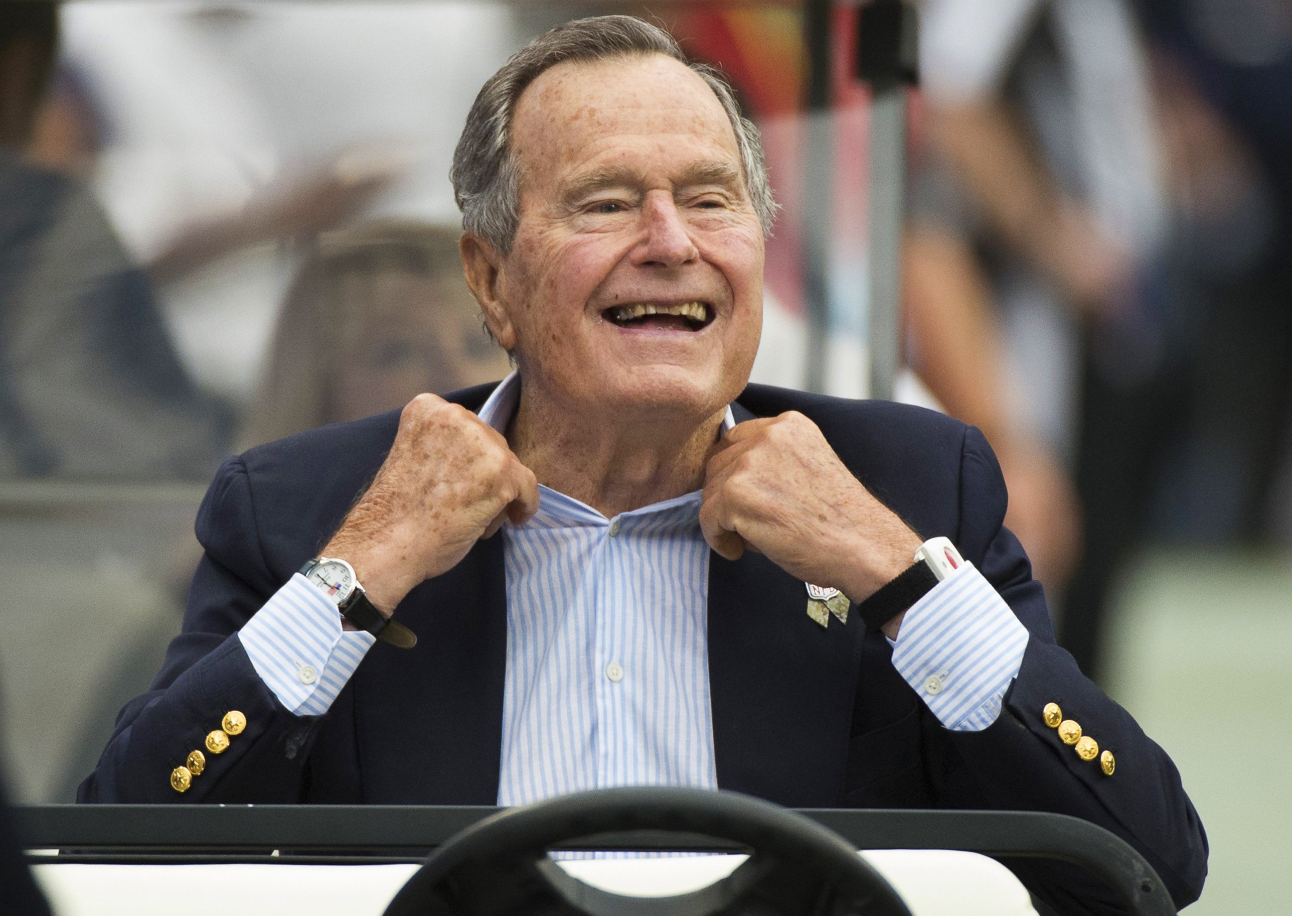 PHOTO: Former President George H.W. Bush sits on the sidelines before a game between the Houston Texans and Oakland Raiders, in Houston, in this Nov. 17, 2013 photo.