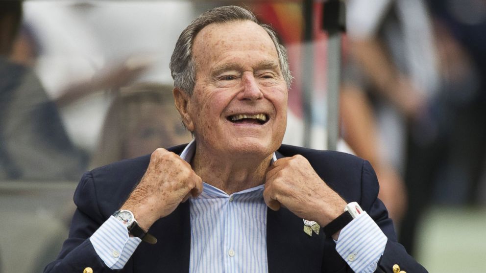 Former President George H.W. Bush sits on the sidelines before a game between the Houston Texans and Oakland Raiders, in Houston, in this Nov. 17, 2013 photo.