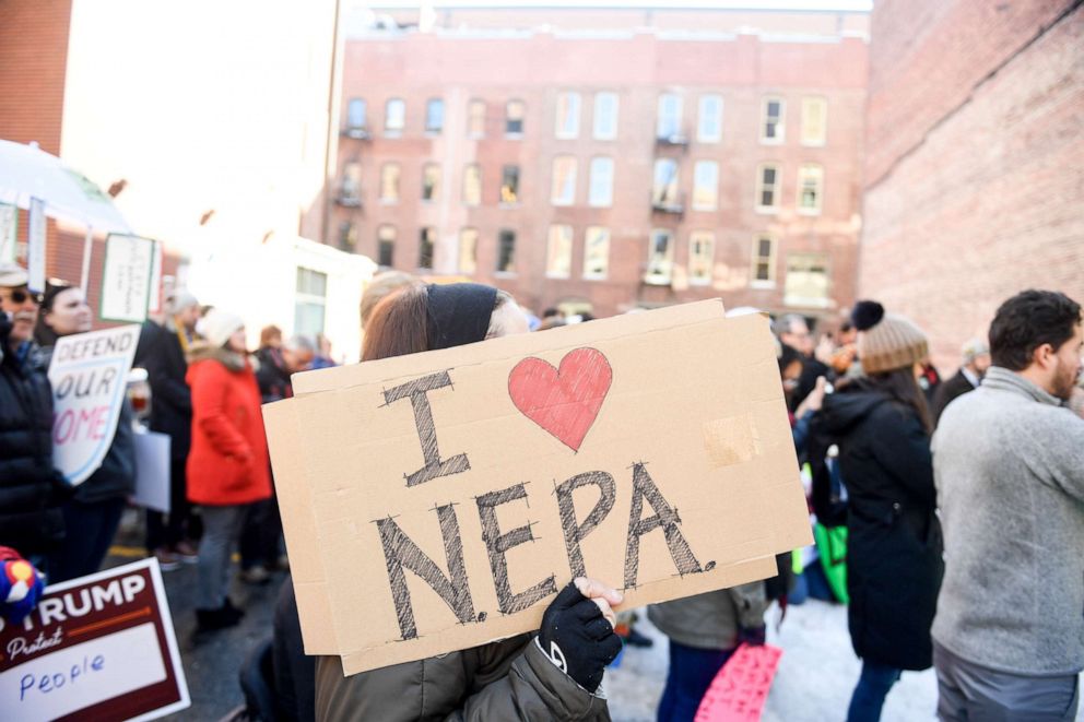 PHOTO: Activists gather outside of the Alliance Center across the street from a public hearing by the Council on Environmental Quality's proposed update to NEPA Regulations on Tuesday, Feb. 11, 2020.