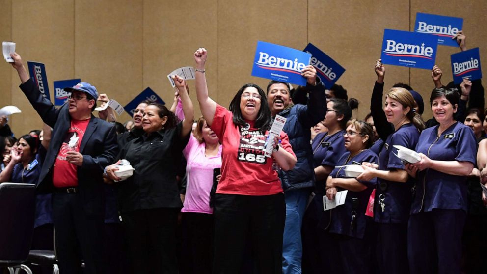 PHOTO: Bellagio hotel workers hold Bernie placards before caucusing at the Bellagio Hotel in Las Vegas, Feb. 22, 2020.