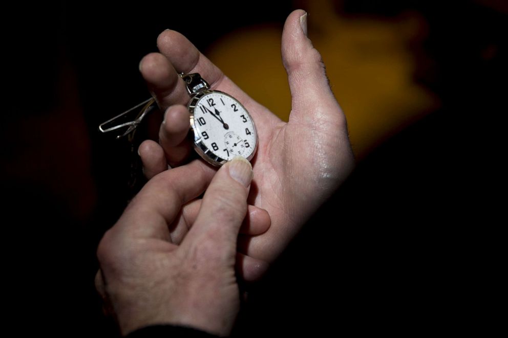 PHOTO: A reporter for the Conway Daily Sun looks at a watch before voting begins at the town hall polling site during the New Hampshire presidential primary election in Harts Location, N.H., Feb. 8, 2016.