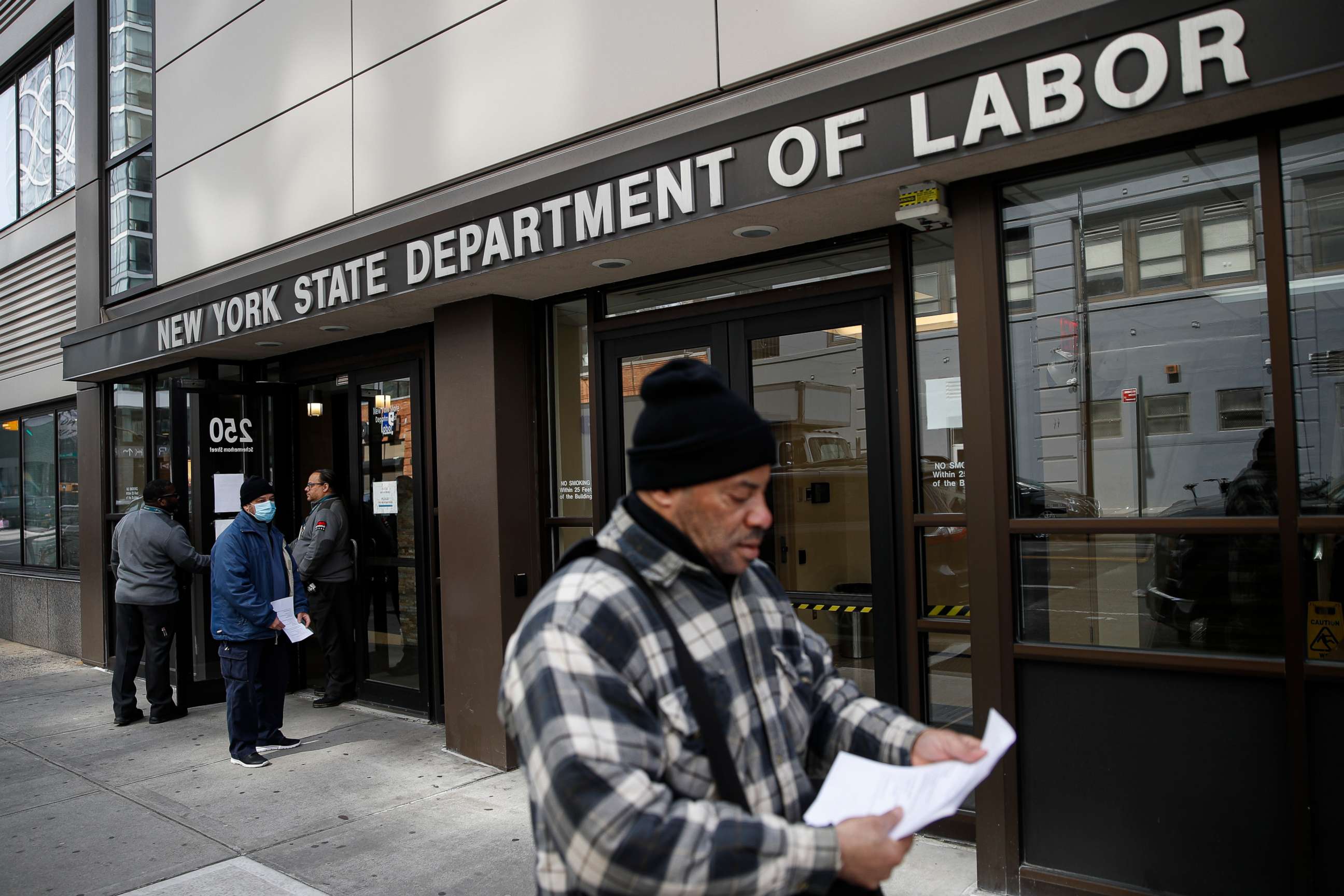PHOTO: Visitors to the Department of Labor are turned away at the door by personnel due to closures over coronavirus concerns, Wednesday, March 18, 2020, in New York.