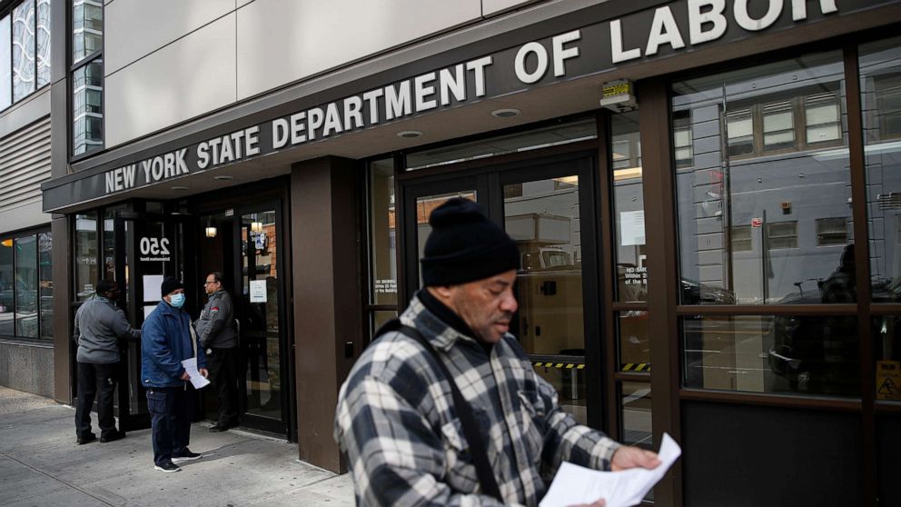 PHOTO: Visitors to the Department of Labor are turned away at the door by personnel due to closures over coronavirus concerns, Wednesday, March 18, 2020, in New York. Applications for jobless benefits are surging as coronavirus concerns shake the economy.