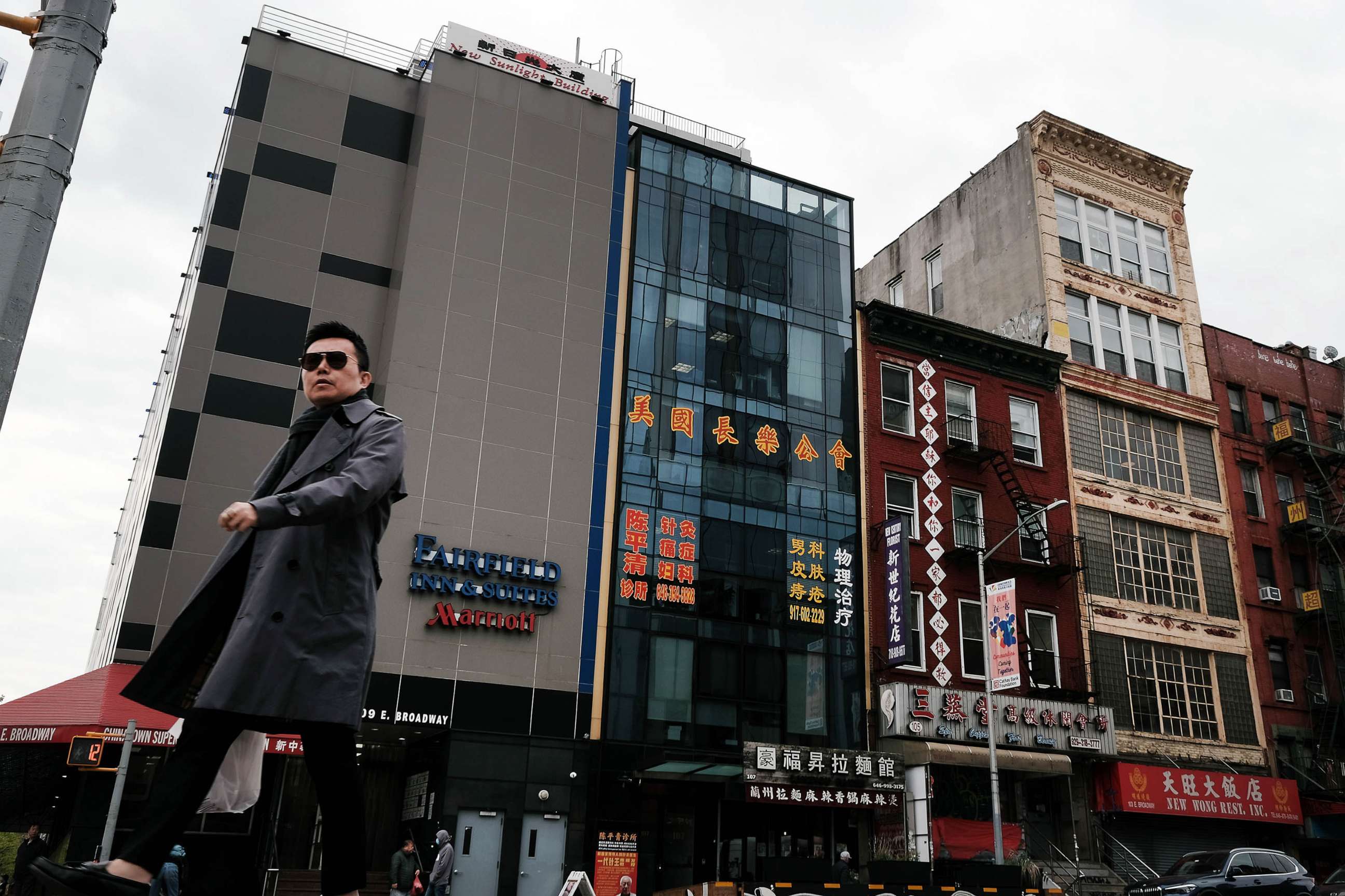 PHOTO: People walk by a building (C)that is suspected of being used as a secret police station in Chinatown for the purpose of repressing dissidents living in the United States on behalf of the Chinese government stands in lower Manhattan, April 18, 2023.