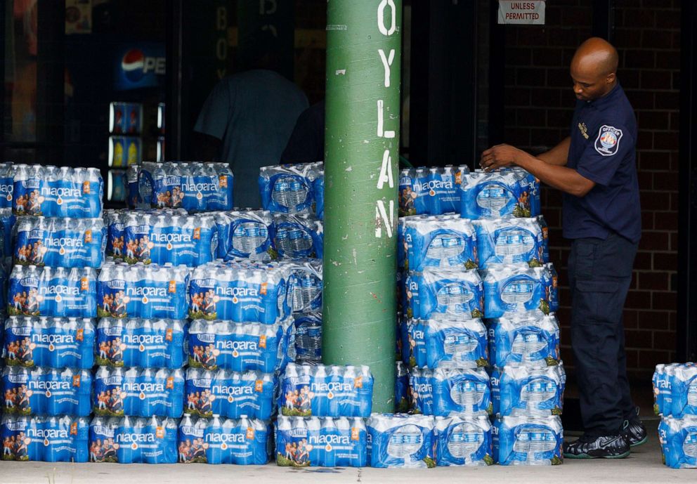 PHOTO: A city worker piles packages of bottled water being offered to area residents at a city-run bottled water distribution site at a community center in Newark, N.J., Aug. 16, 2019.