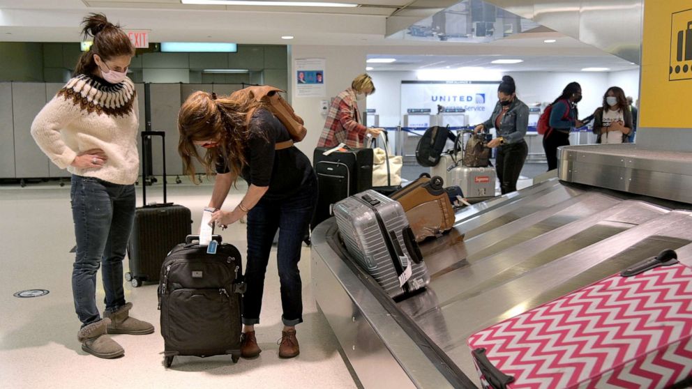 PHOTO: Air travelers collect their checked baggage at Newark International Airport, Oct. 27, 2020 in Newark, New Jersey.