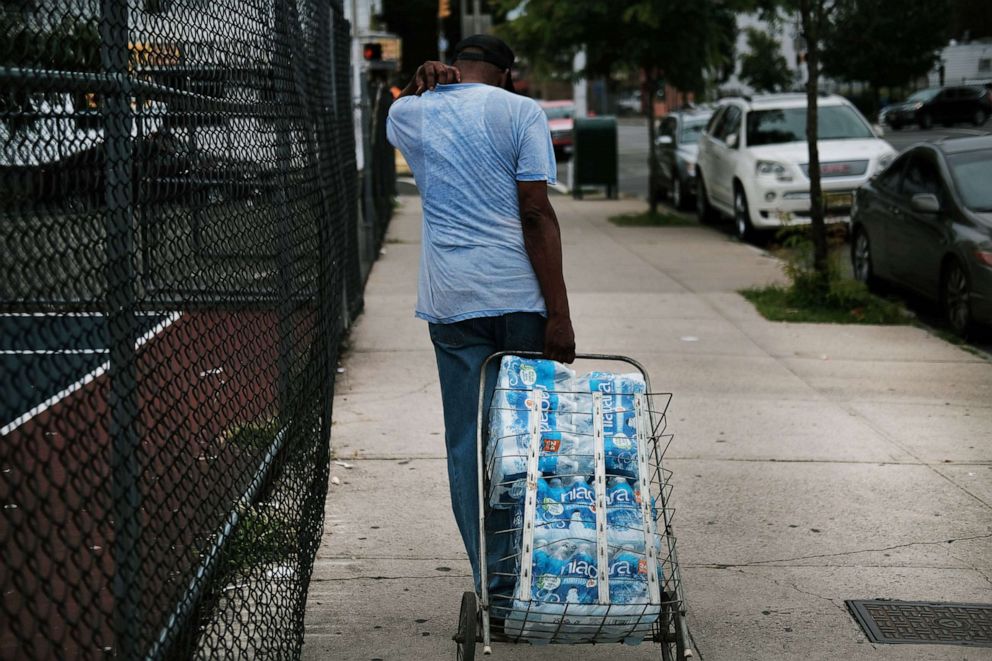 PHOTO: A resident takes bottled water home after receiving it at a recreation center, Aug. 13, 2019 in Newark, N.J., after lead was found in the tap water.
