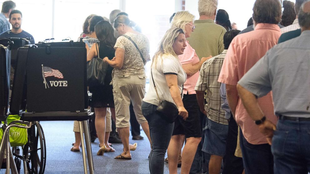 Voters waited in long lines at the polling place in Daskalos Plaza to vote in New Mexico's primary election, June 5, 2018, in Albuquerque, N.M.