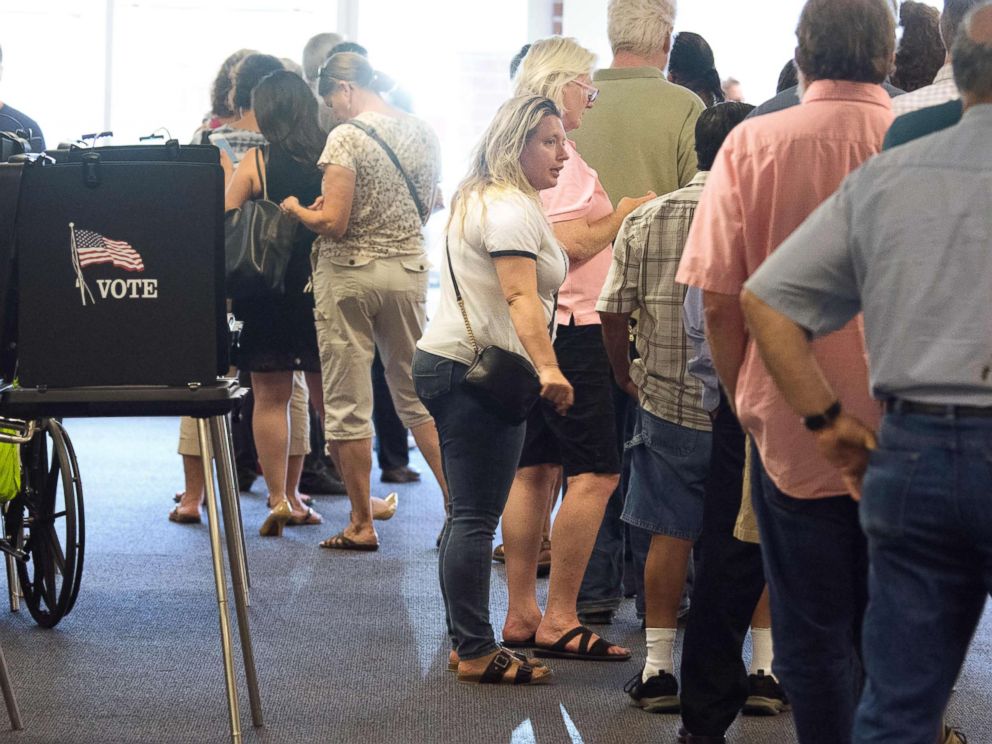 Voters waited in long lines at the polling place in Daskalos Plaza to vote in New Mexico's primary election, June 5, 2018, in Albuquerque, N.M.