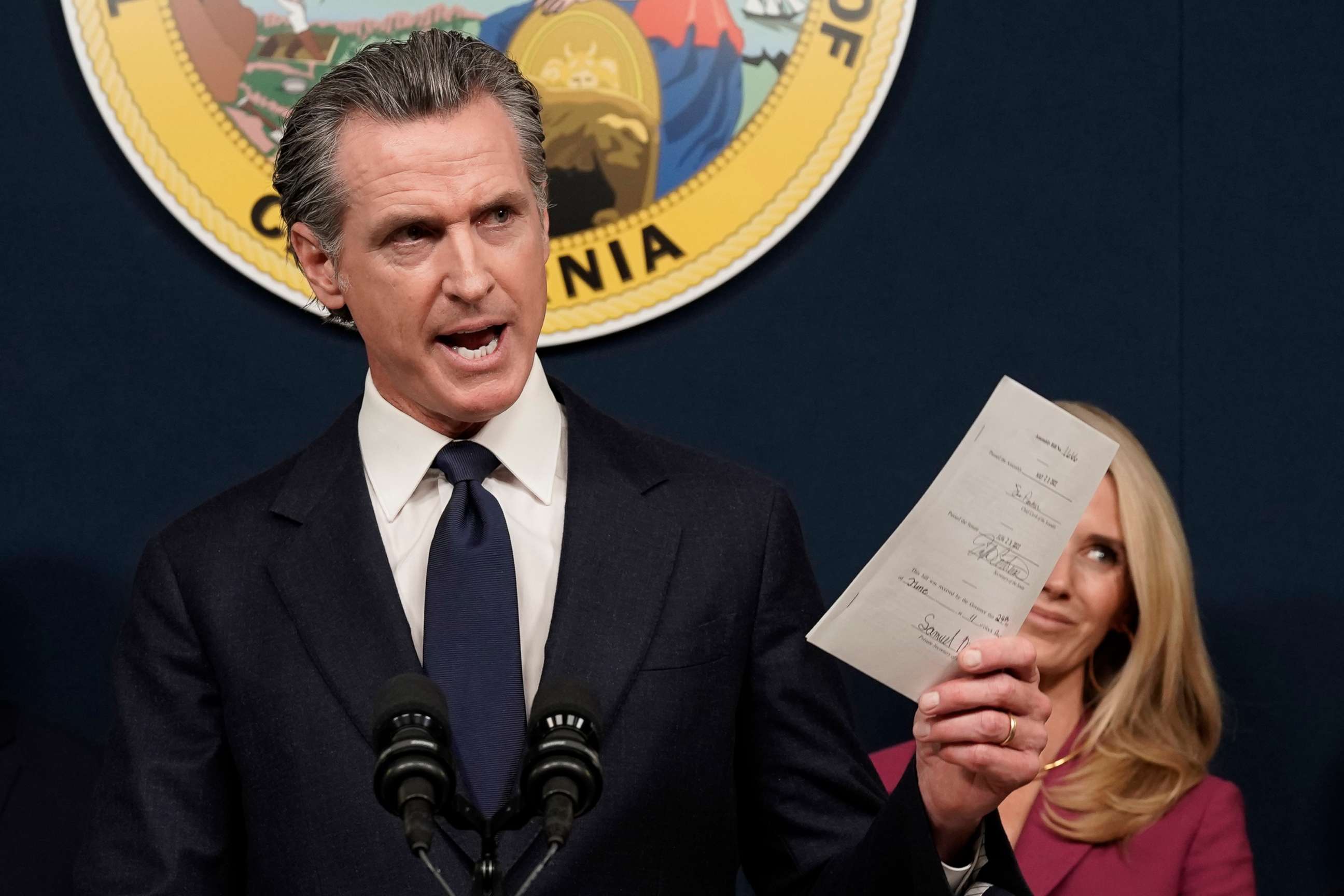 PHOTO: California Gov. Gavin Newsom displays a bill he signed during a news conference in Sacramento, Calif., June 24, 2022.