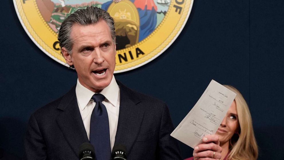 PHOTO: California Gov. Gavin Newsom displays a bill he signed during a news conference in Sacramento, Calif., June 24, 2022.