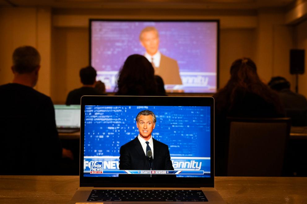 PHOTO: Reporters watch from an off-site hotel as Florida Gov. Ron DeSantis and California Gov. Gavin Newsom debate, Nov .30, 2023.
