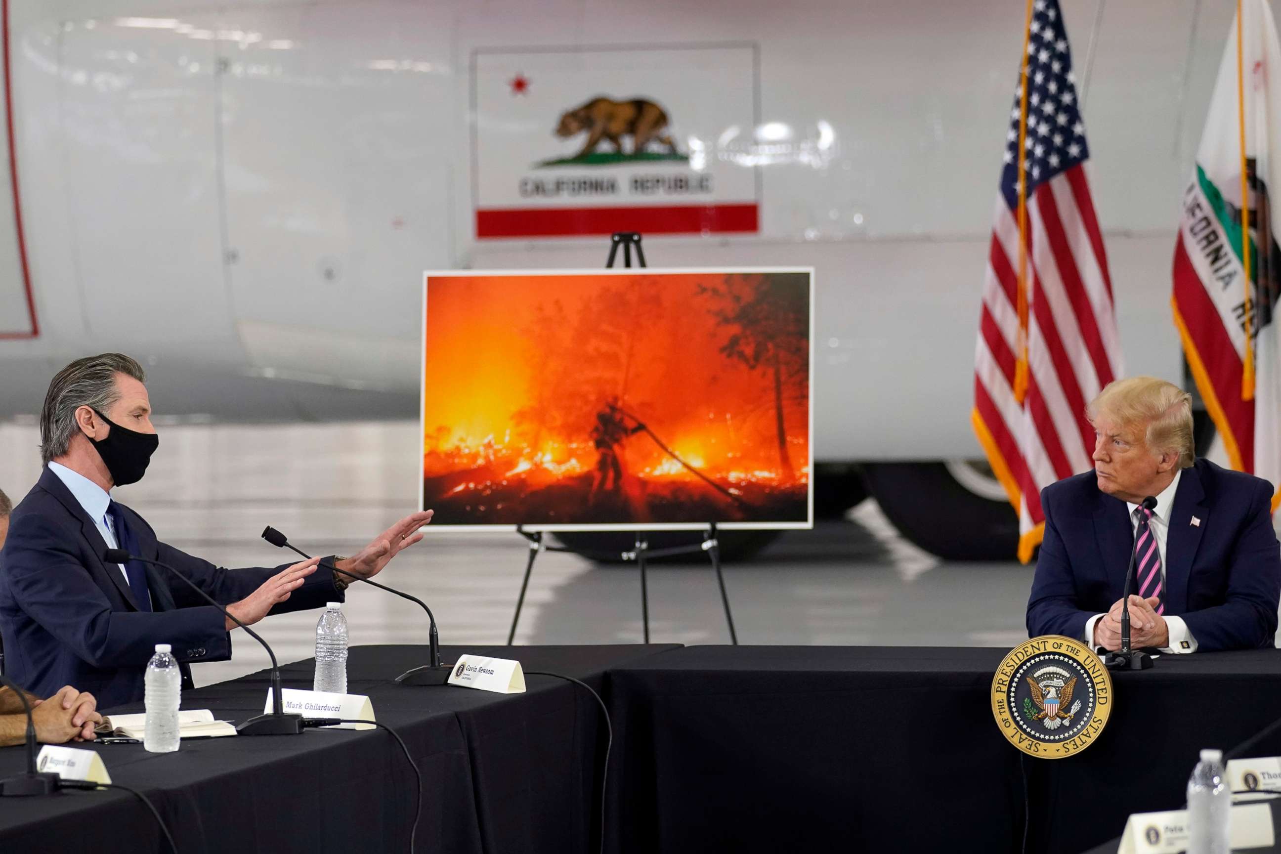 PHOTO: President Donald Trump listens as California Gov. Gavin Newsom, left, speaks about the western wildfires during a briefing at Sacramento McClellan Airport, in McClellan Park, Calif., Sept. 14, 2020.