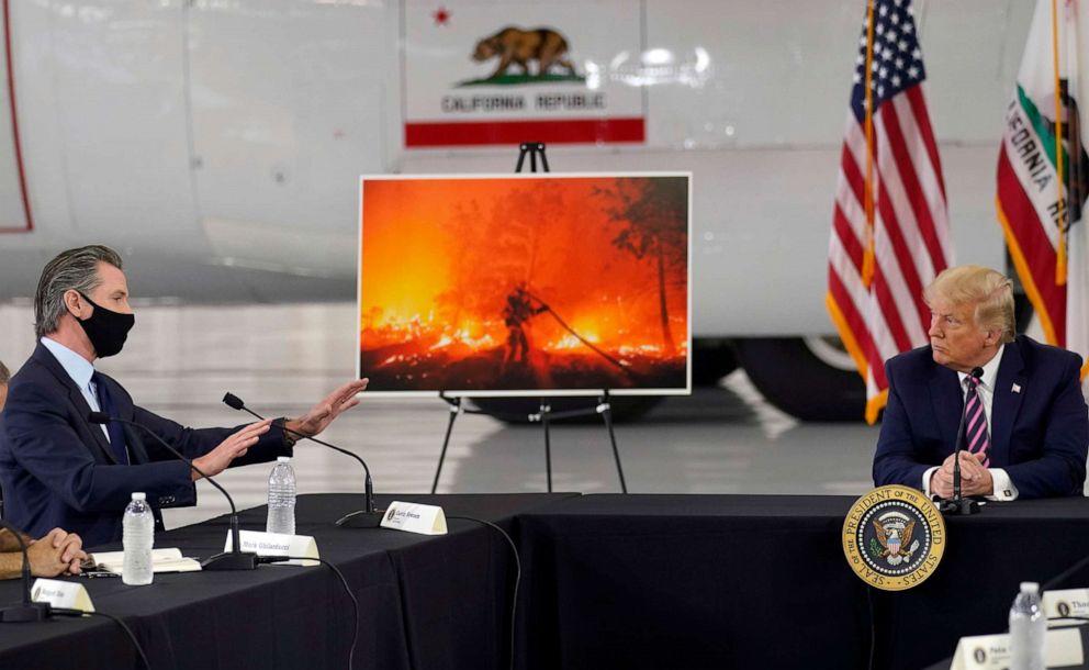 PHOTO: President Donald Trump listens as California Gov. Gavin Newsom, left, speaks about the western wildfires during a briefing at Sacramento McClellan Airport, in McClellan Park, Calif., Sept. 14, 2020.