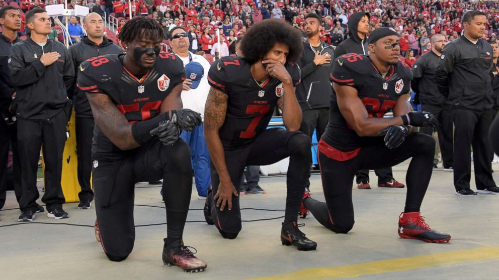 PHOTO: San Francisco 49ers outside linebacker Eli Harold (58), quarterback Colin Kaepernick (7) and free safety Eric Reid (35) kneel in protest during the playing of the national anthem in Santa Clara, Calif., Oct 6, 2016. 