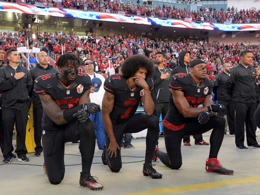 PHOTO: San Francisco 49ers outside linebacker Eli Harold (58), quarterback Colin Kaepernick (7) and free safety Eric Reid (35) kneel in protest during the playing of the national anthem in Santa Clara, Calif., Oct 6, 2016.
