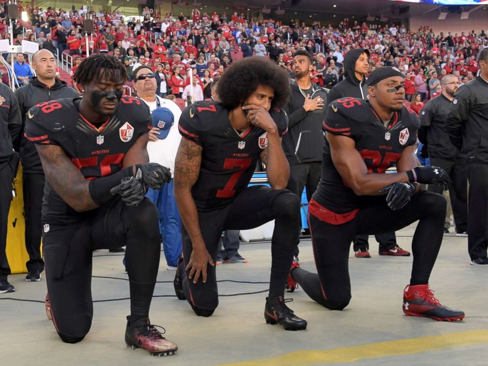 PHOTO: San Francisco 49ers outside linebacker Eli Harold (58), quarterback Colin Kaepernick (7) and free safety Eric Reid (35) kneel in protest during the playing of the national anthem in Santa Clara, Calif., Oct 6, 2016. 