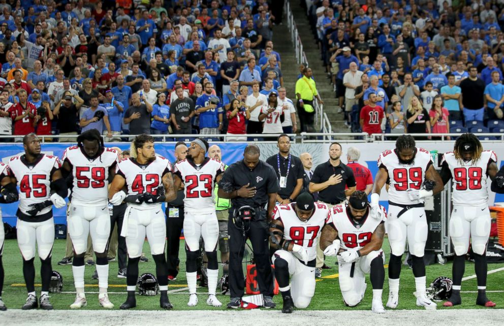 PHOTO: Members of the Atlanta Falcons football team, Grady Jarrett and Dontari Poe, take a knee during the playing of the national anthem prior to the start of the game against the Detroit Lions  at Ford Field on Sept. 24, 2017 in Detroit.