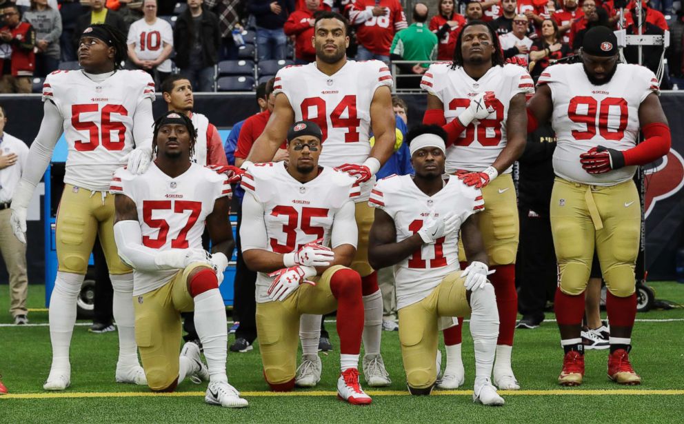 PHOTO: San Francisco 49ers' Eli Harold (57), Eric Reid (35) and Marquise Goodwin (11) kneel during the national anthem before an NFL football game against the Houston Texans, in Houston, Dec. 10, 2017.