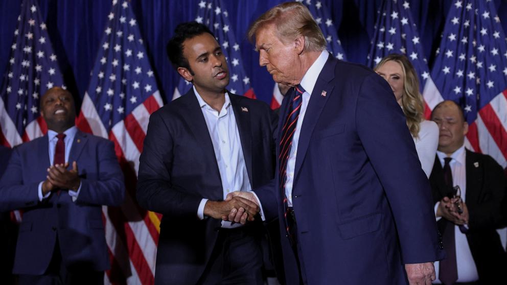 PHOTO: Republican presidential candidate and former President Donald Trump shakes hands with former Republican presidential candidate Vivek Ramaswamy during his New Hampshire presidential primary watch party, in Nashua, New Hampshire, Jan. 23, 2024. 