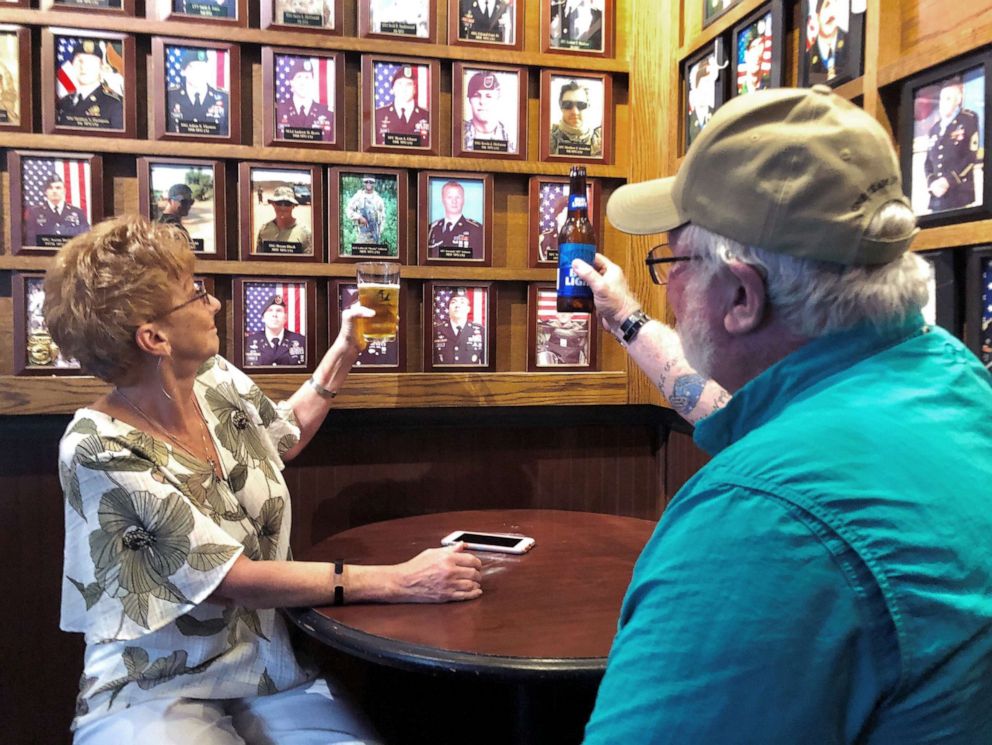 PHOTO: Debra and Ray Gannon toast her son Sgt. 1st Class Jeremiah Johnson at Charlie Mike's bar near Fort Bragg in North Carolina.