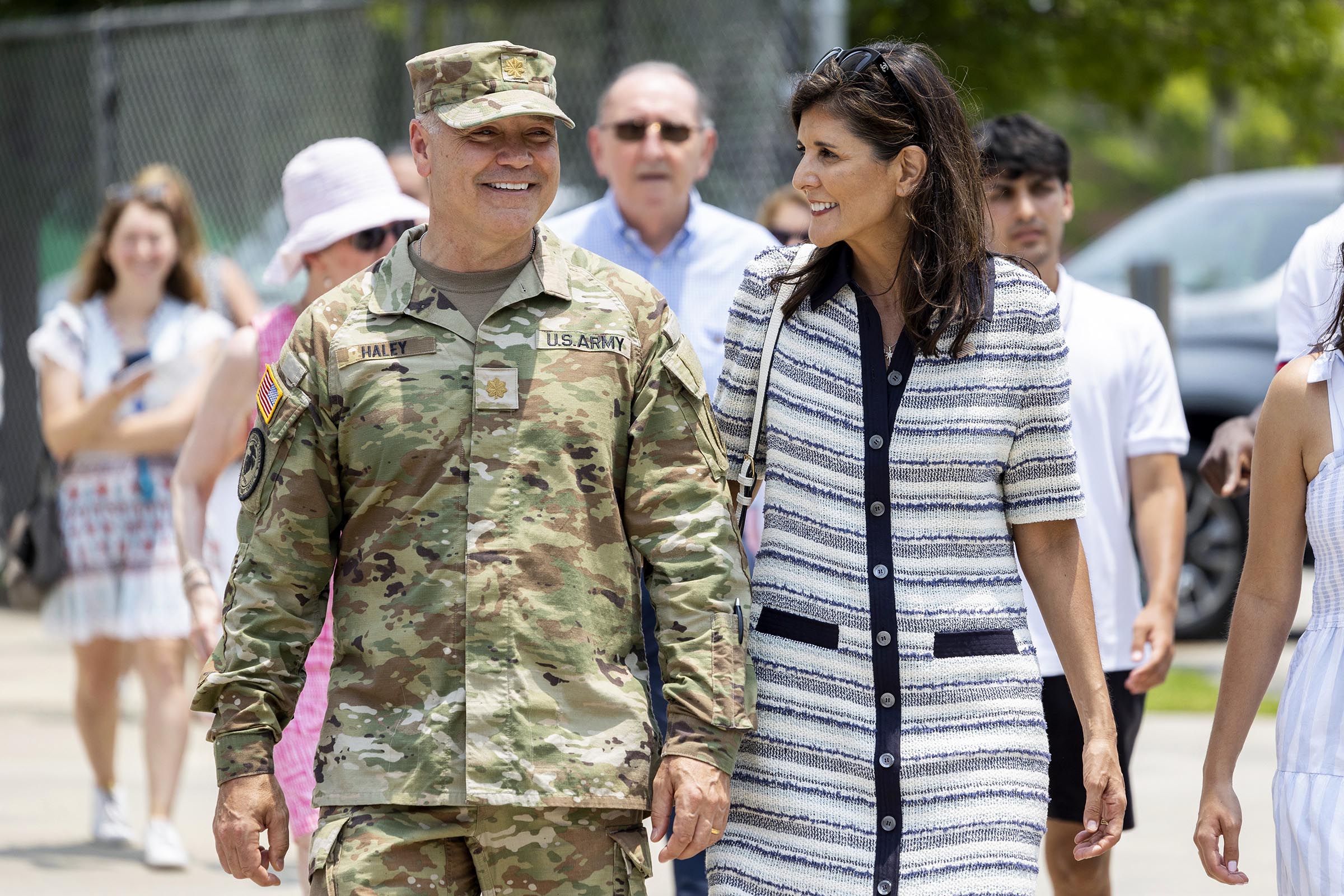 PHOTO: Republican presidential candidate Nikki Haley walks with her husband Maj. Michael Haley following a deployment ceremony for his unit of the South Carolina National Guard on June 17, 2023, at Johnson Hagood Stadium in Charleston, S.C.