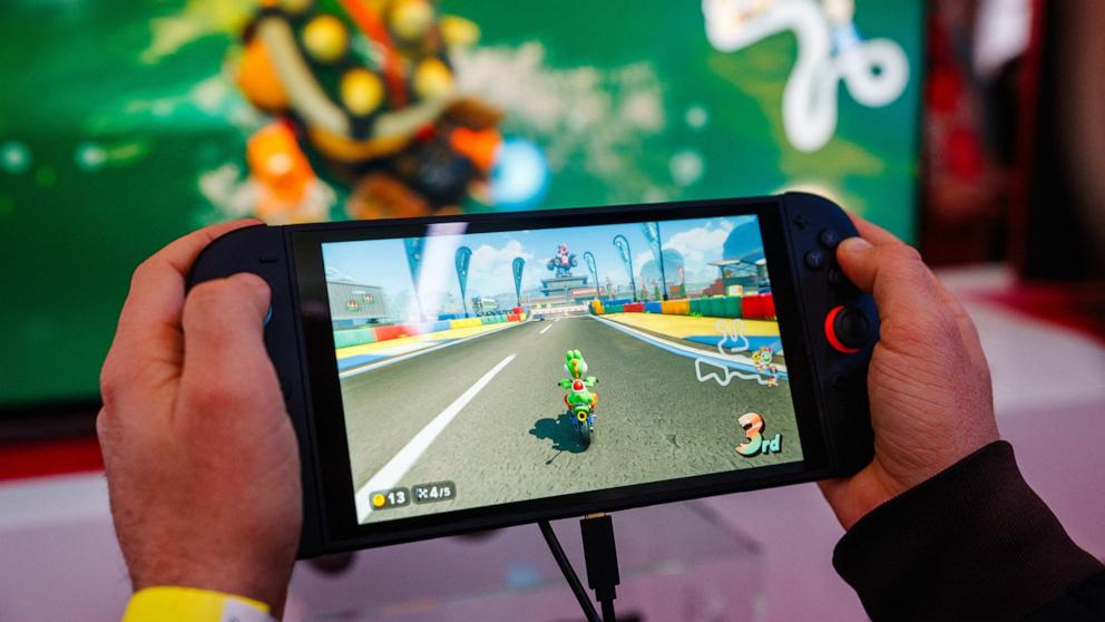 PHOTO: A guest plays Mariokart World with the new Nintendo Switch 2 video-game console system of Japanese video-game company Nintendo during the worldwide presentation at the Grand Palais in Paris on April 2, 2025.
