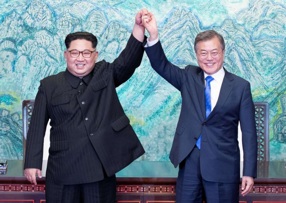 PHOTO: North Korean leader Kim Jong Un and South Korean President Moon Jae-in raise their hands at the truce village of Panmunjom inside the demilitarized zone separating the two Koreas, South Korea, April 27, 2018.