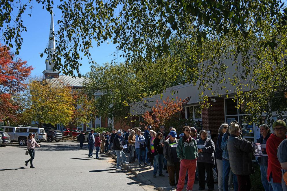 PHOTO: A large line of potential voters wait outside an early voting site on Oct. 17, 2024 in Asheville, N.C.