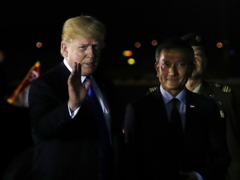 PHOTO: U.S. President Donald Trump waves next to Singapores Foreign Minister Vivian Balakrishnan after arriving in Singapore, June 10, 2018.