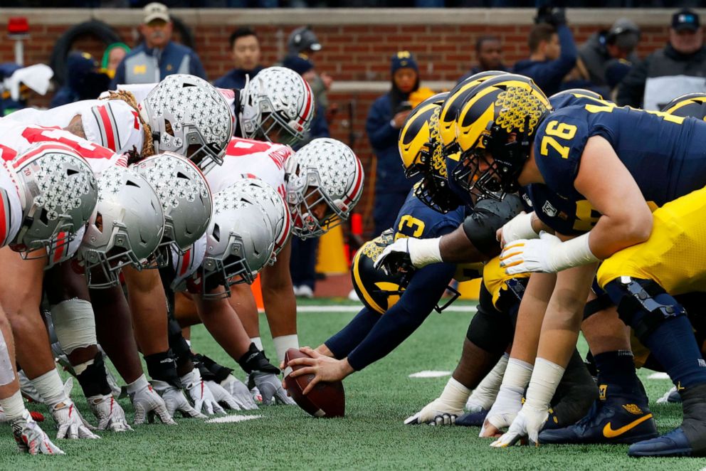 PHOTO: Ohio State and Michigan players line up at the line of scrimmage in the first half of an NCAA college football game in Ann Arbor, Mich., Nov. 30, 2019.