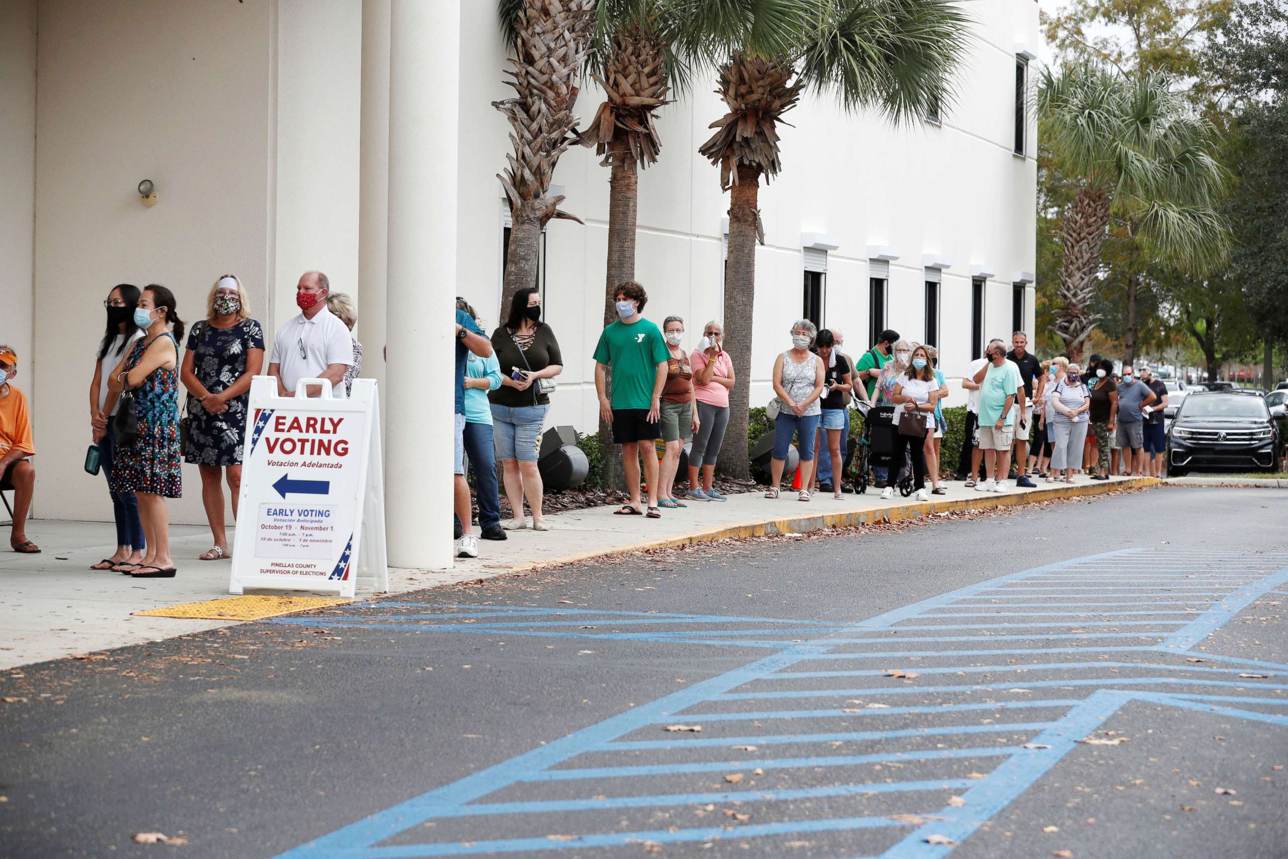 PHOTO: Voters line up at the Supervisor of Elections Office polling station as early voting begins in Pinellas County ahead of the election in Largo, Fla., Oct. 21, 2020.