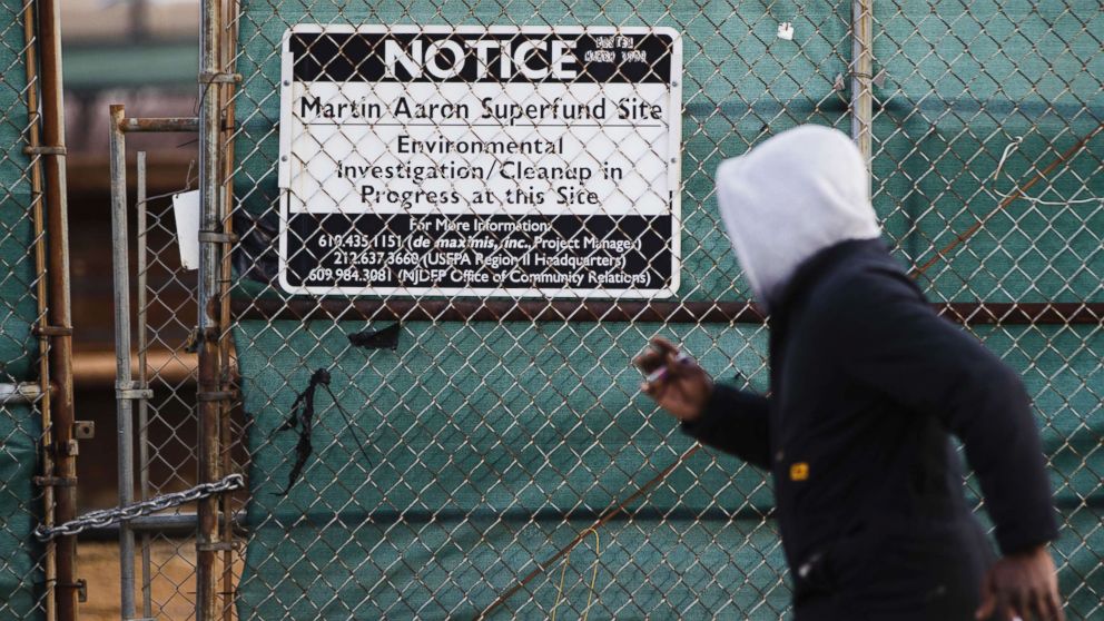 PHOTO: a man walks past a notice for the Martin Aaron Inc. Superfund site in Camden, N.J., Dec. 11, 2017.