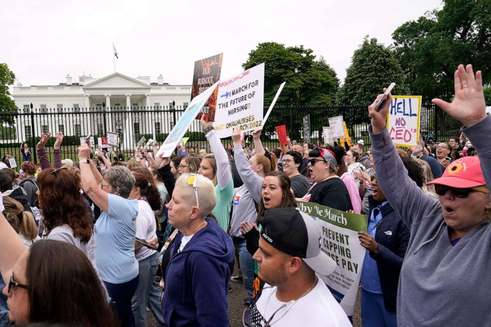 PHOTO: People march outside the White House protesting working conditions of nurses, in Washington, D.C., May 12, 2022. They ask for improved wages, staffing environments and no violence against healthcare workers.