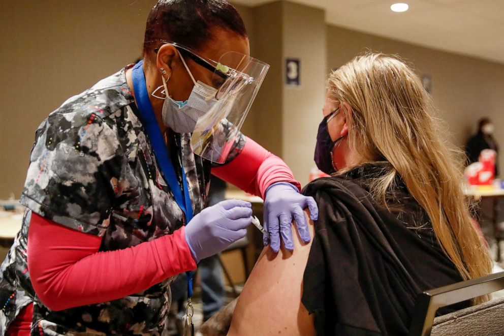 PHOTO: A woman receives a Johnson & Johnson Covid-19 vaccine from registered nurse Gina Reed at a vaccination center established at the Hilton Chicago O'Hare Airport Hotel in Chicago, March 5, 2021.