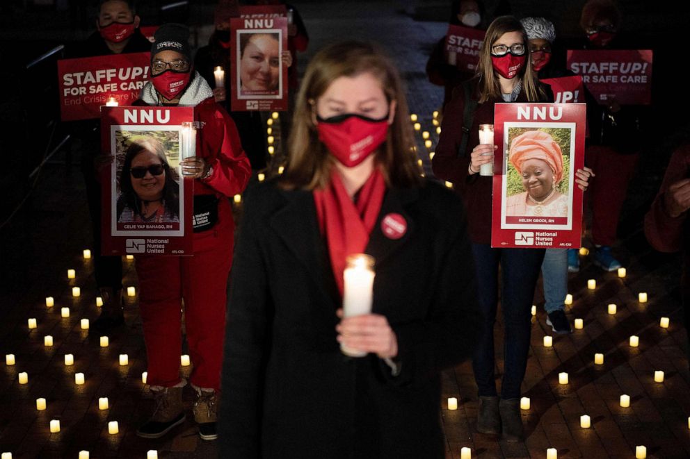 PHOTO: Activists hold images of nurses who died during the COVID-19 pandemic during a vigil in Lafayette Park, Jan. 13, 2022, in Washington, D.C.
