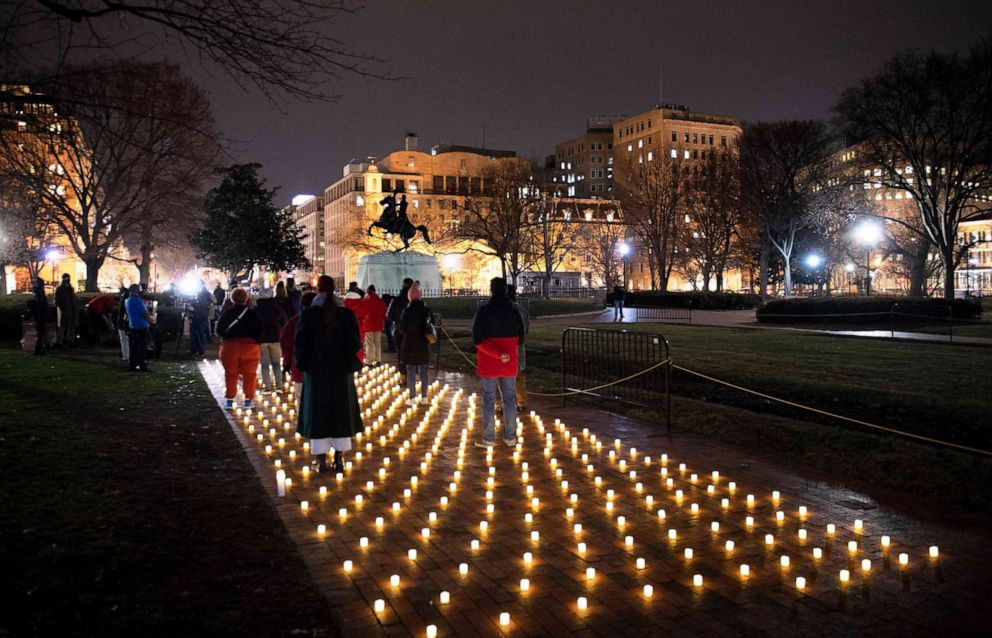 PHOTO: Activists gather during a vigil in Lafayette Park for nurses who died during the COVID-19 pandemic, Jan. 13, 2022, in Washington, D.C. 