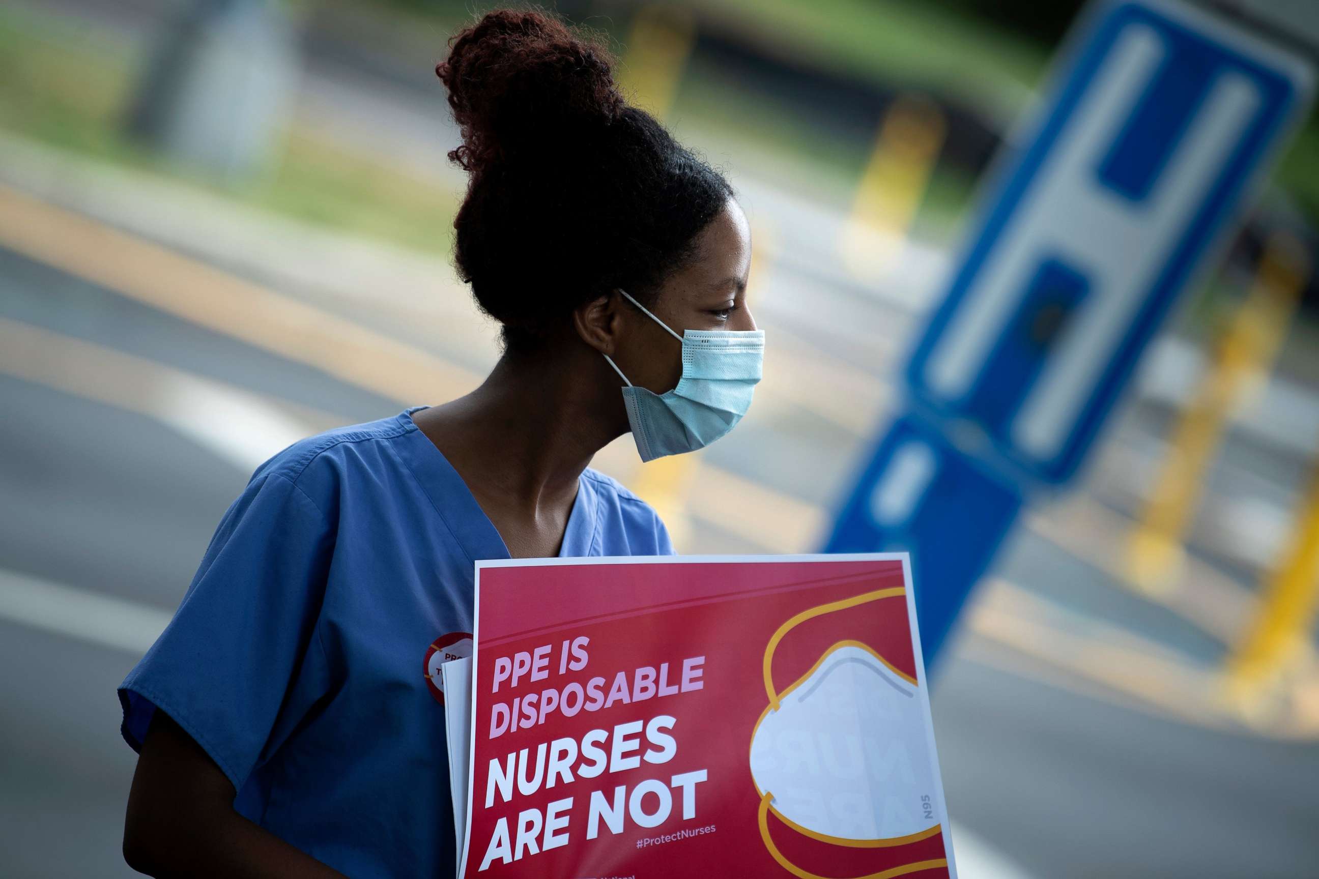 PHOTO: Yuhana Gidey (L), a nurse at Washington hospital center who survived COVID-19, protests demanding better Personal Protective Equipment outside MedStar's Washington Hospital Center on July 23, 2020, in Washington, DC.