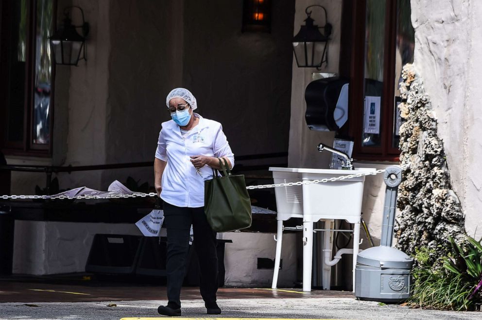 PHOTO: A medical staff person walks out of Fair Havens Center nursing home facilities in Miami Springs, on May 11, 2020.