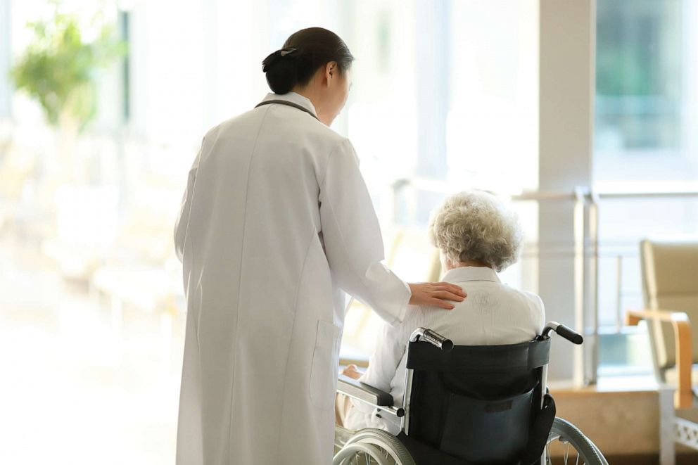 PHOTO: In this undated file photo, a retirement home staff member helps a resident.