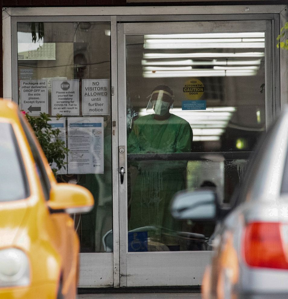 PHOTO: A person in protective gear is pictured inside the Brier Oak on Sunset nursing home in Los Angeles, April 18, 2020. 