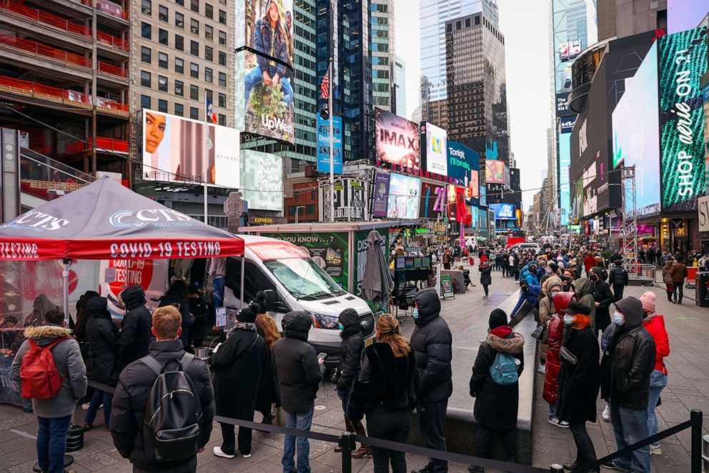 PHOTO: People stand in a queue for a coronavirus disease (COVID-19) test in Times Square as the Omicron coronavirus variant continues to spread in New York City, Dec. 19, 2021.