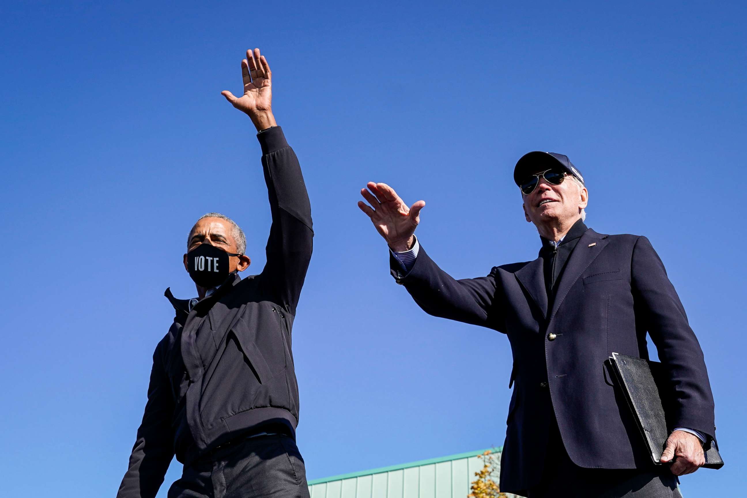 PHOTO: Former President Barack Obama and Democratic presidential nominee Joe Biden wave to the crowd at the end of a drive-in campaign rally at Northwestern High School, Oct. 31, 2020, in Flint, Michigan.